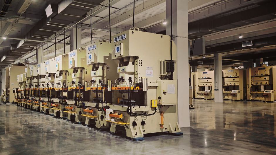 A row of industrial machines on a factory floor, highlighting manufacturing equipment. (Photo: Mazhar Ulazhar / Pexels)