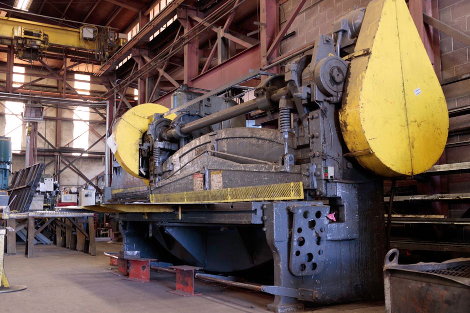 Heavy-duty industrial machine in a factory's production line, showcasing machinery details. (Photo: J E / Pexels)