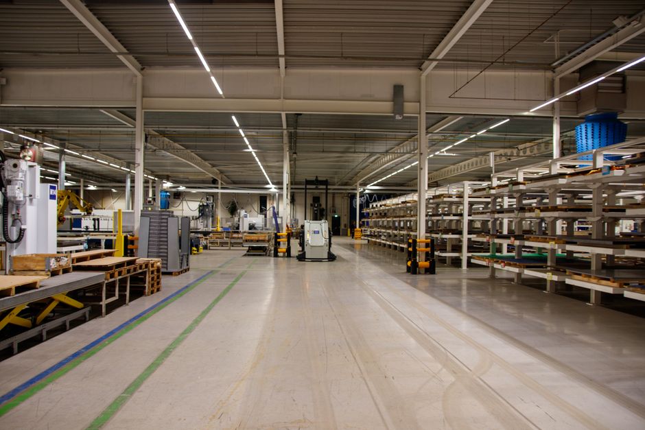 Spacious industrial warehouse interior featuring machinery and storage shelves. (Photo: Freek Wolsink / Pexels)