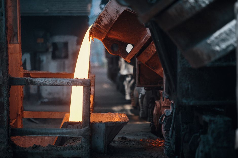 Molten metal pouring in a foundry, showcasing intense industrial processes. (Photo: Bence Szemerey / Pexels)