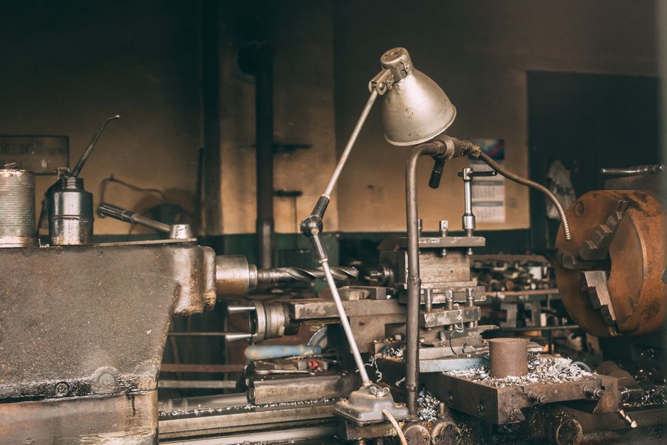 A rusty industrial lathe in a vintage workshop setting showcasing metalwork machinery. (Photo: Marian  Cosnete / Pexels)