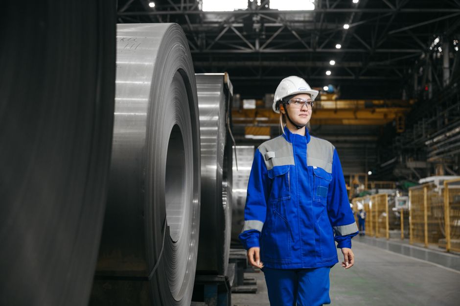 Female industrial worker in protective gear at a steel manufacturing facility. (Photo: Sergey Sergeev / Pexels)
