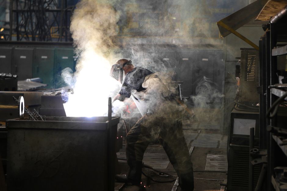 A skilled welder working with intense sparks and smoke in an industrial workshop, showcasing safety and precision. (Photo: Kateryna Babaieva / Pexels)