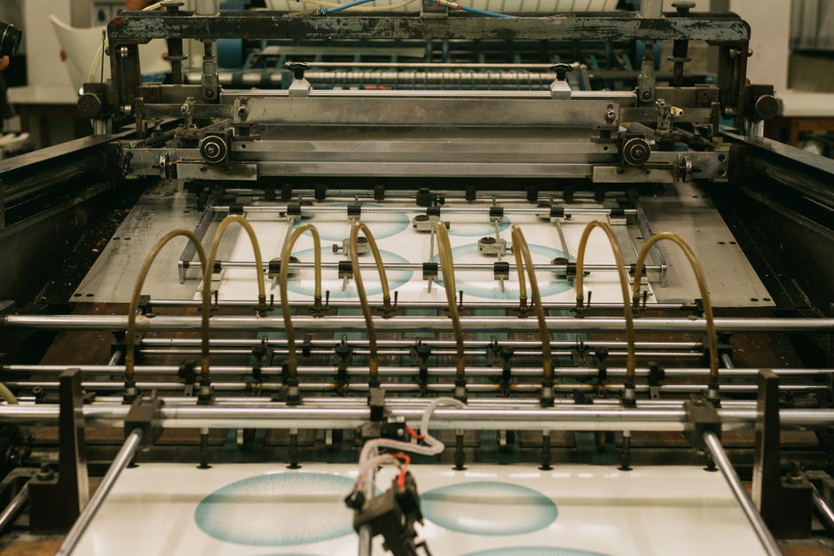 Close-up of an industrial printing press producing designs. (Photo: João  Jesus / Pexels)