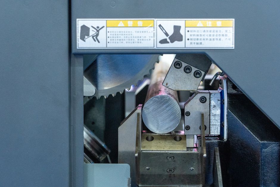 Detailed view of a metal cutting machine in operation, showcasing industrial machinery. (Photo: Peter Xie / Pexels)